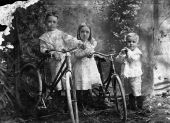 Henderson siblings posing with bicycles.