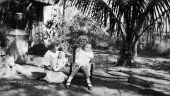 Maizie with doll, and her brother being held by unidentified person