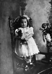 Girl holding a stuffed dog.