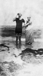 Two men on the beach in bathing suits