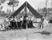 Florida National Guardsmen standing before camp mess tent