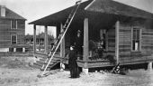 Edna Johns Miller standing beside a house - High Springs, Florida.