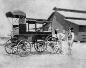 Pair of men posing with carriage