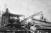 Skidder loading logs on Florida and Alabama track at Munson