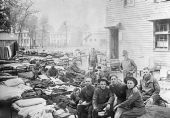 Soldiers relaxing on cots outside barracks - Camp Joseph E. Johnston
