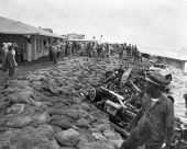 Seawall reinforced with sandbags and junk automobiles after being washed out by northeast storm.
