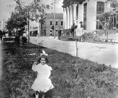 Young girl standing in front of library under construction.