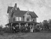 Large unidentified group of people on the porch and grounds of a Lake County home