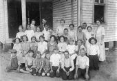 Children shown in front of school