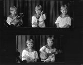 Little boy with bear, telephone and banjo.