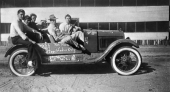 Six people in a car with writing on it - Panacea, Florida.
