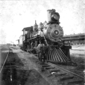 Gus Anderson standing beside engine number 9