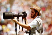 Photographer for the Tallahassee Democrat posing with camera.