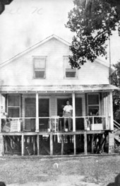 Ridney Albury standing on the porch of his home - Tavernier, Florida.