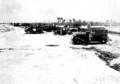 View from the ferry slip looking northeast over the highway at wrecked cars