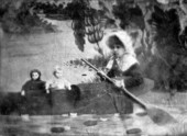 Maud Hamilton Myers Palmer and dolls sitting in a canoe.