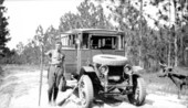 Alexander O. Taylor posing near truck with dead rattlesnake.