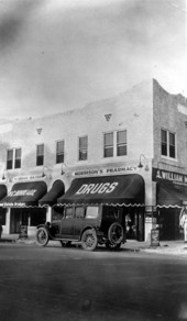 Automobile parked in front of Morrison's Pharmacy - Miami, Florida.