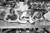 Boys competing in a watermelon eating contest during festival - Leesburg, Florida