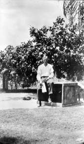 Unidentified man sits on a crate - Miami , Florida