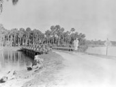 Woman crossing bridge over the Pithlachascotee River, New Port Richey.