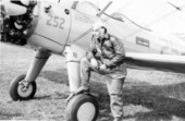 Pilot posing with a Stearman PT-17 plane during primary flight training at Dorr Field in Arcadia, Florida.
