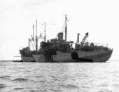 "U.S.S. St. George," AV-16 seaplane tender, commanded by Captain Robert G. Armstrong, at anchor with PBM "Mariner" aboard for repairs