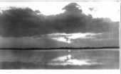 Sun hovering over the water