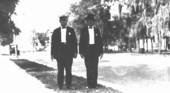Two men wearing badges