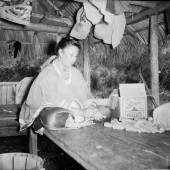 Seminole woman making dolls