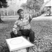 Seminole Indian Medicine Man Josie Billie sitting in chair in front of a Wheel of Life