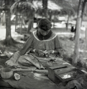 Seminole woman weaving baskets