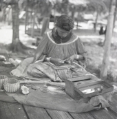 Seminole woman weaving baskets