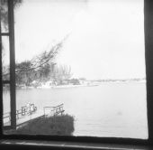 Person sitting on dock overlooking body of water
