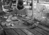 Seminole woman weaving baskets