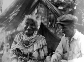 Man smoking with an elderly Seminole woman