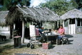 Seminole Indians at a table having lunch - Charlie Dixie Camp, Florida