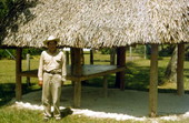 Seminole Indian man standing by a chickee - Brighton Reservation, Florida