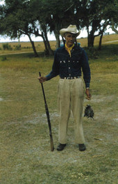 Seminole Indian man with shotgun and catch at the Brighton Indian Reservation