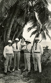 George Merrick and others standing next to palm trees