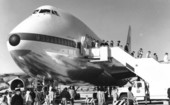 Passengers disembarking an airplane.
