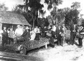 Large group around tray of tomatoes