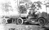 Two men on an early tanker truck