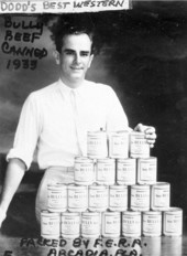 Man displaying cans of Bully Beef