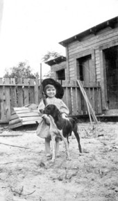 Portrait of an unidentified girl with toy gun and dog