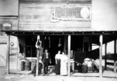 Man and woman outside their store.