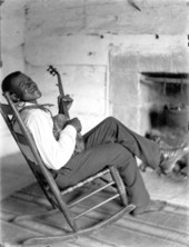 African American man playing a banjo.