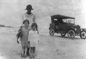 Family standing next to its car at a Mayport beach