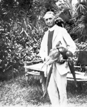 Pastor with pet macaws.