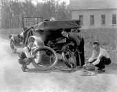 Men changing tire.